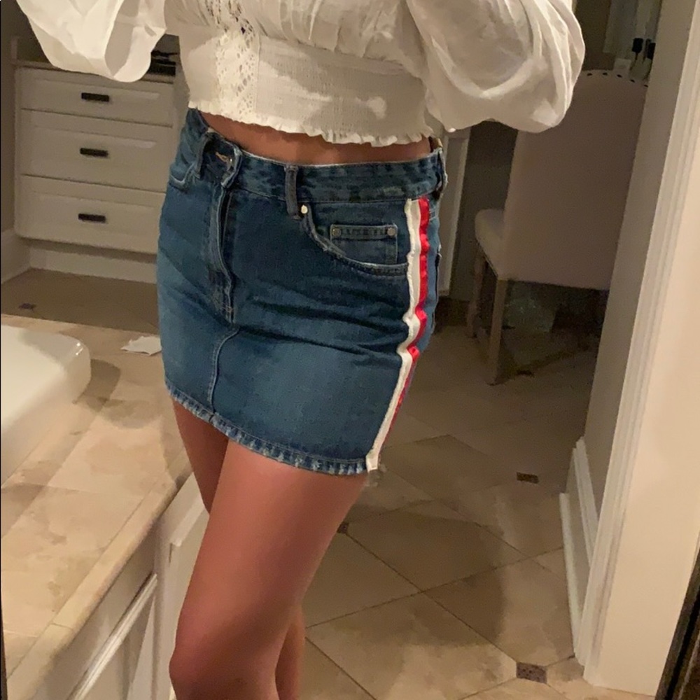 Denim skirt with white and red stripe on sides